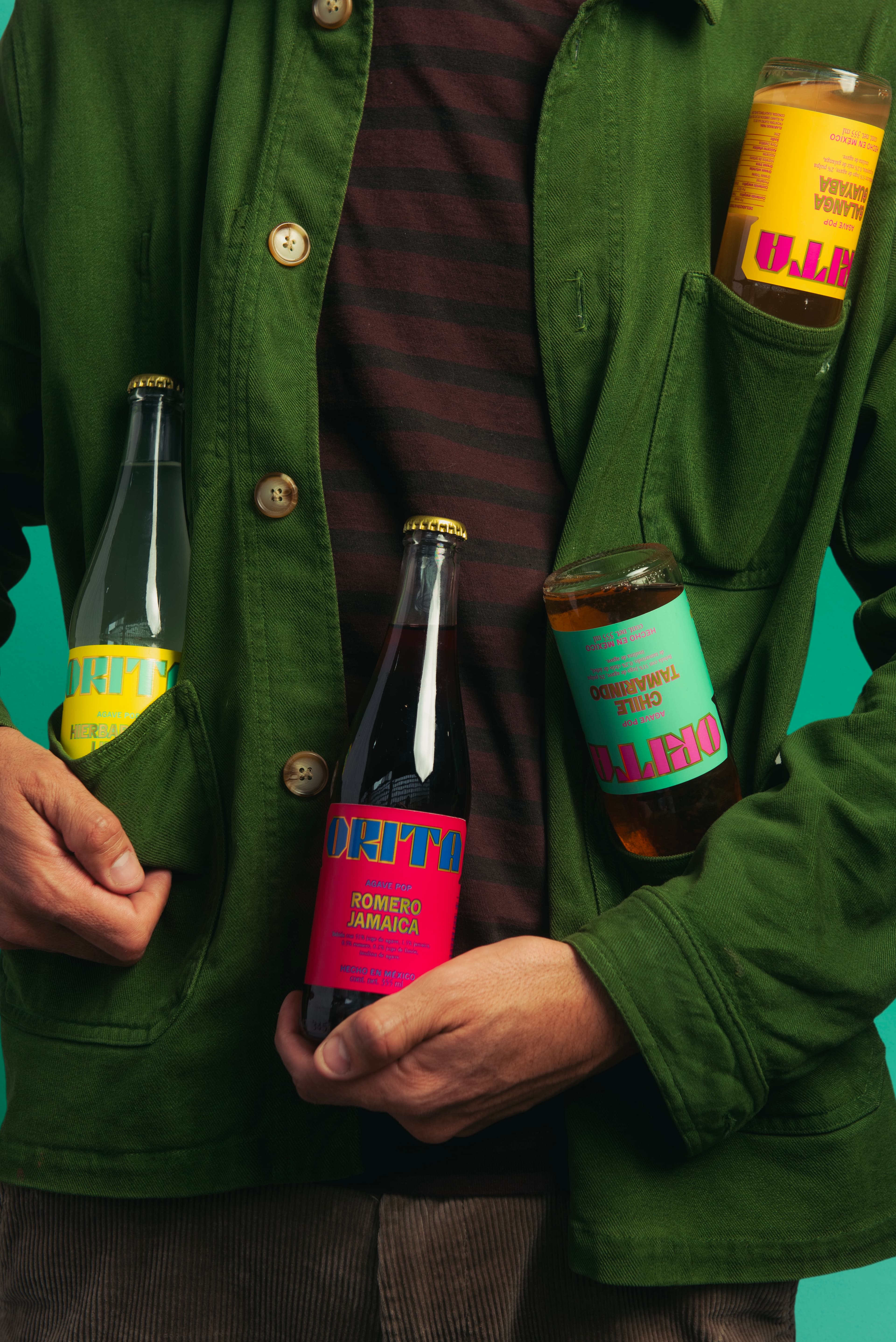 Orita Agave Pop - Person holding bottles